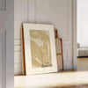 Henri Matisse paper cutouts in abstract shapes with gray and orange tones - leaning on a herringbone floor against a white panelled wall