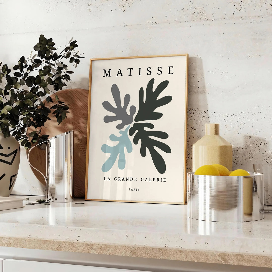 Gray and white Matisse papier découpé abstract poster in modern style. - styled on a counter with eucalyptus and a bowl of lemons
