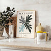 Gray and white Matisse papier découpé abstract poster in modern style. - styled on a counter with eucalyptus and a bowl of lemons