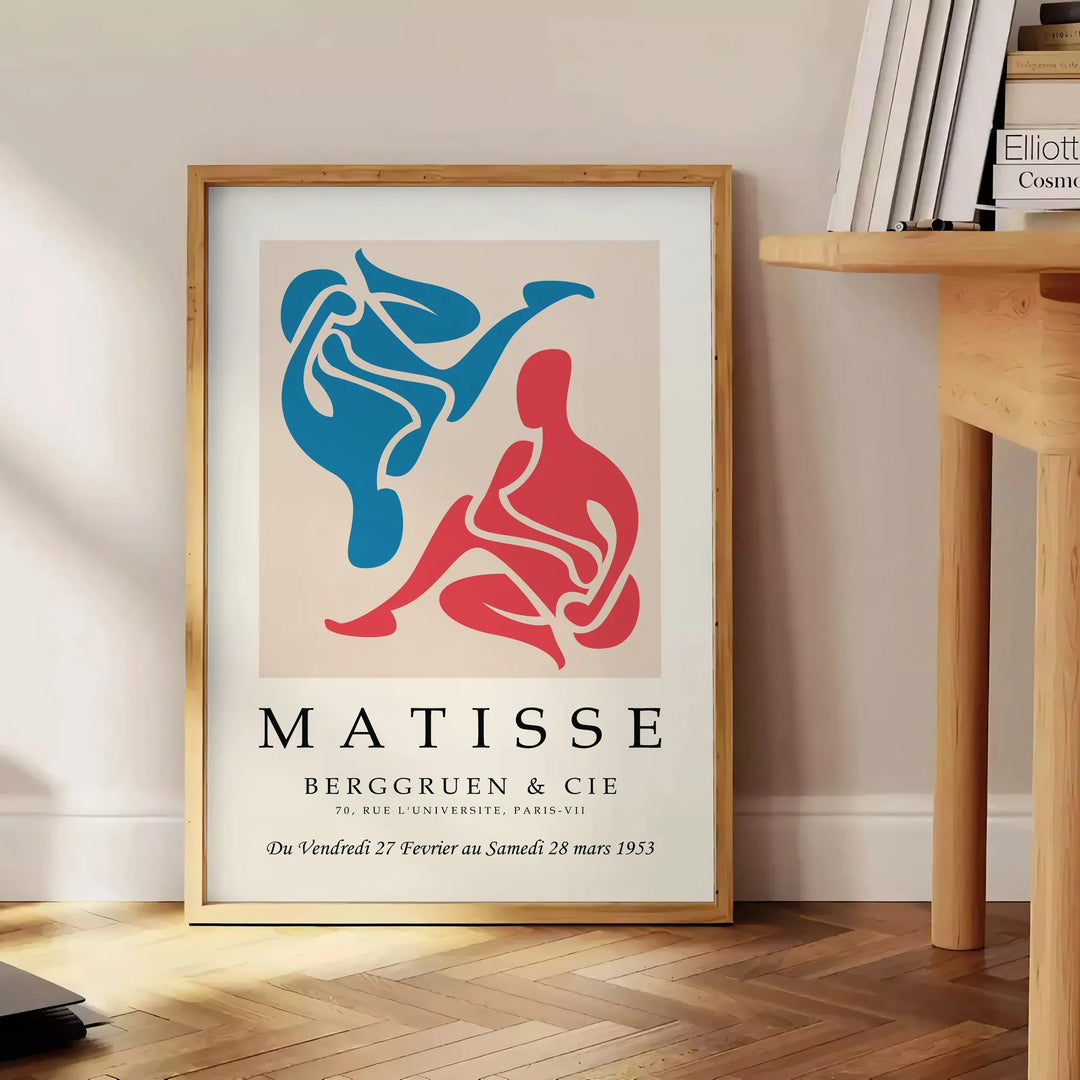 Colorful abstract cut-out shapes in the style of Matisse - beside a round wooden side table with books