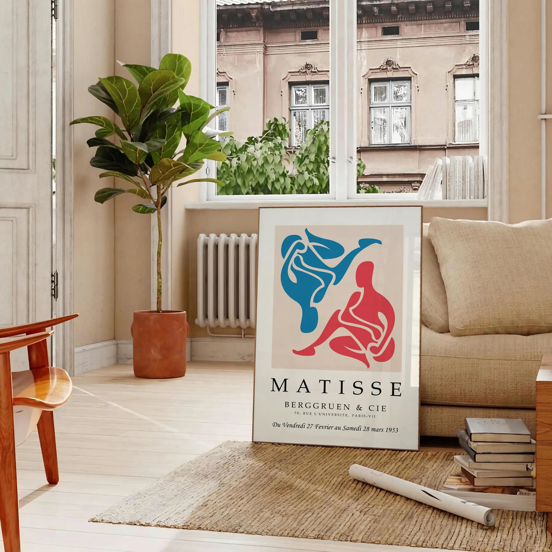 Colorful abstract cut-out shapes in the style of Matisse - in a Parisian living room with a sofa and a fig plant