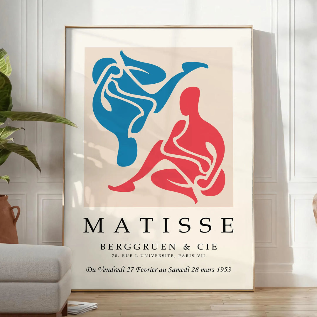 Colorful abstract cut-out shapes in the style of Matisse - in a bright minimalist room with a plant and an armchair