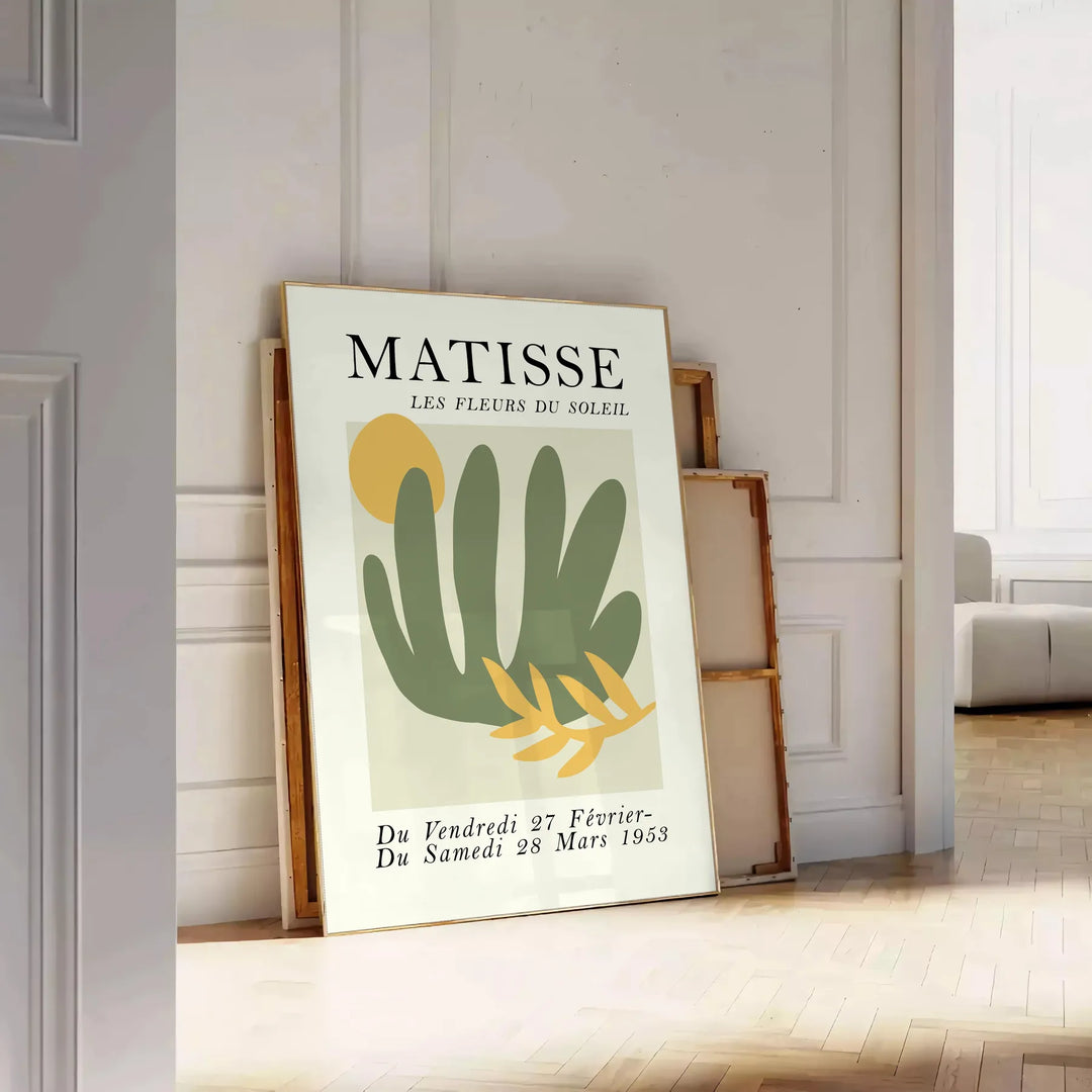 Gray and white poster featuring Matisse-inspired paper cutout abstract composition - leaning on a herringbone floor against a white panelled wall