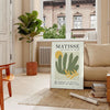 Gray and white poster featuring Matisse-inspired paper cutout abstract composition - in a Parisian living room with a sofa and a fig plant