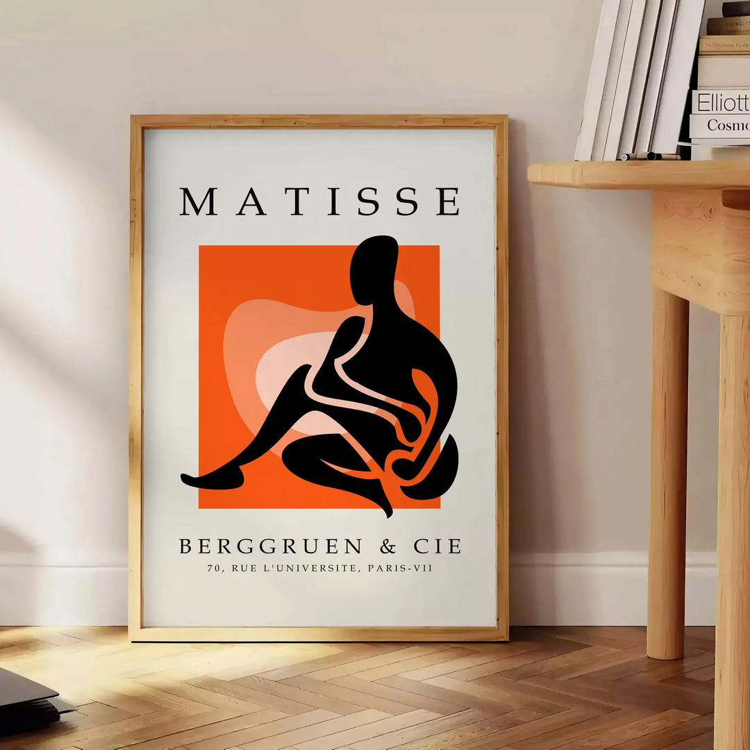 Colorful cut-out shapes in the style of Matisse - beside a round wooden side table with books