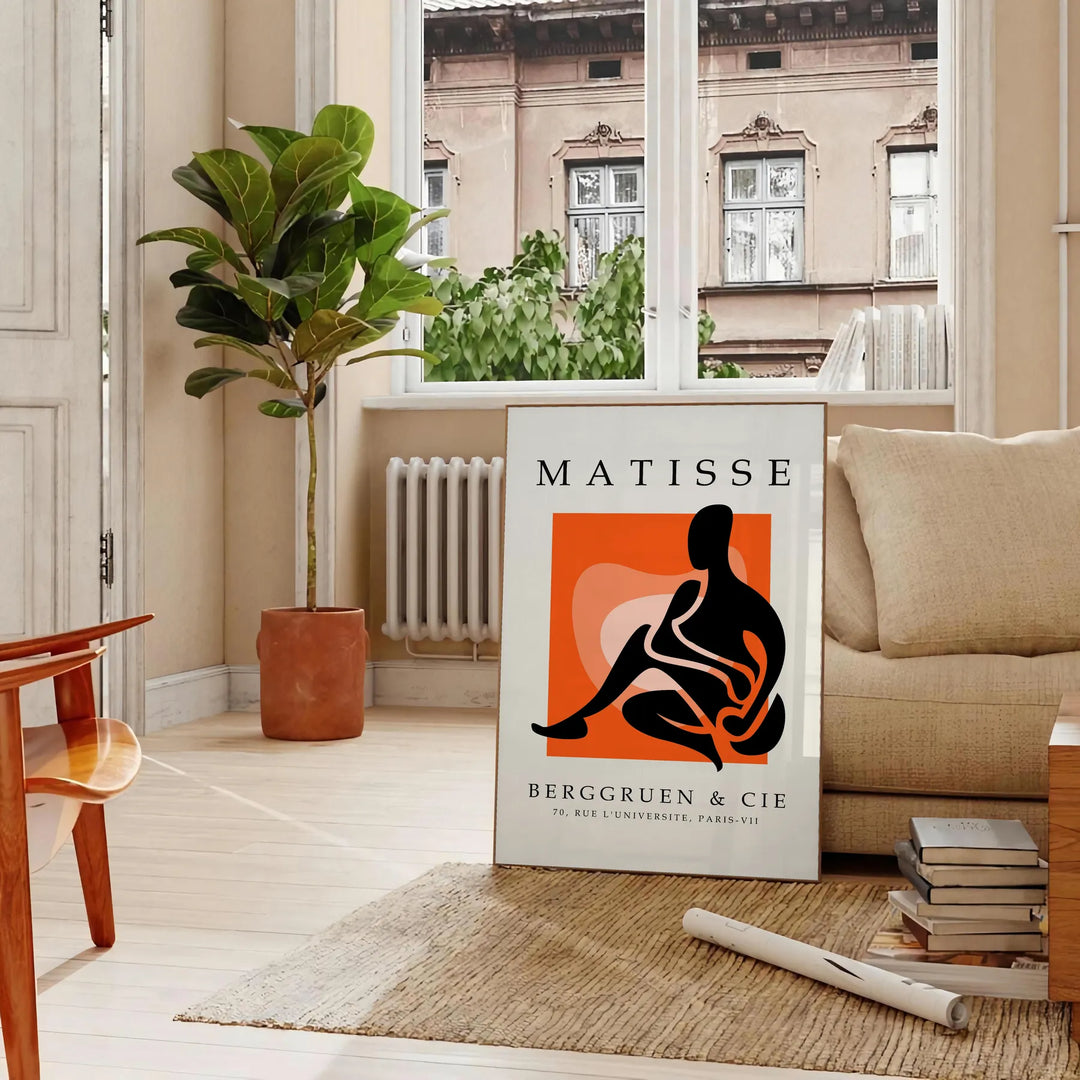 Colorful cut-out shapes in the style of Matisse - in a Parisian living room with a sofa and a fig plant