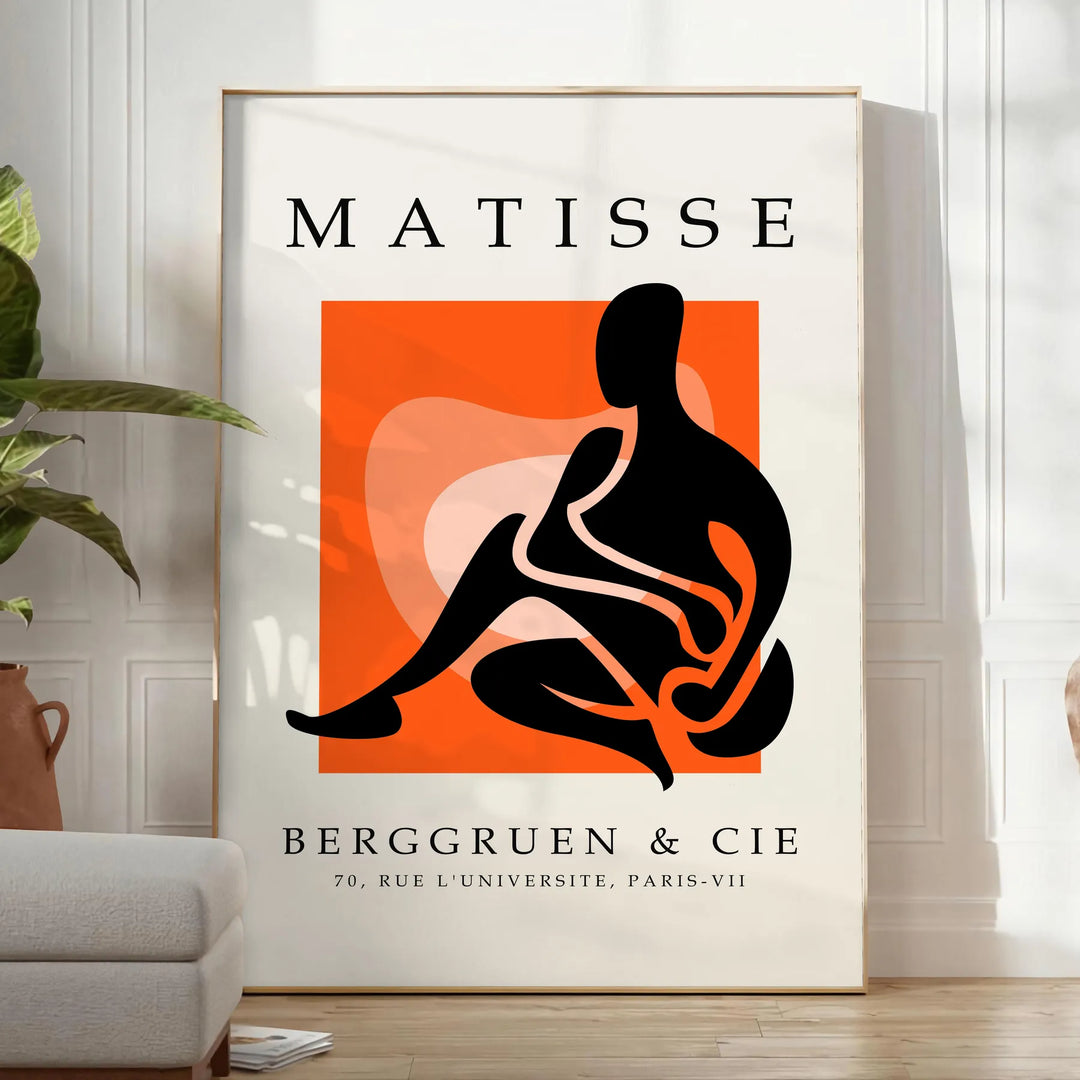 Colorful cut-out shapes in the style of Matisse - in a bright minimalist room with a plant and an armchair