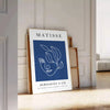 Black and white Matisse cut-outs poster, abstract papier découpés artwork - leaning on a herringbone floor against a white panelled wall