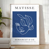 Black and white Matisse cut-outs poster, abstract papier découpés artwork - in a bright minimalist room with a plant and an armchair