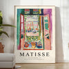Matisse-inspired cutout design with orange and blue shapes - in a bright minimalist room with a plant and an armchair