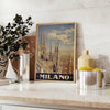 Stylized illustration of Milan's skyline with bold black and green colors - styled on a counter with eucalyptus and a bowl of lemons
