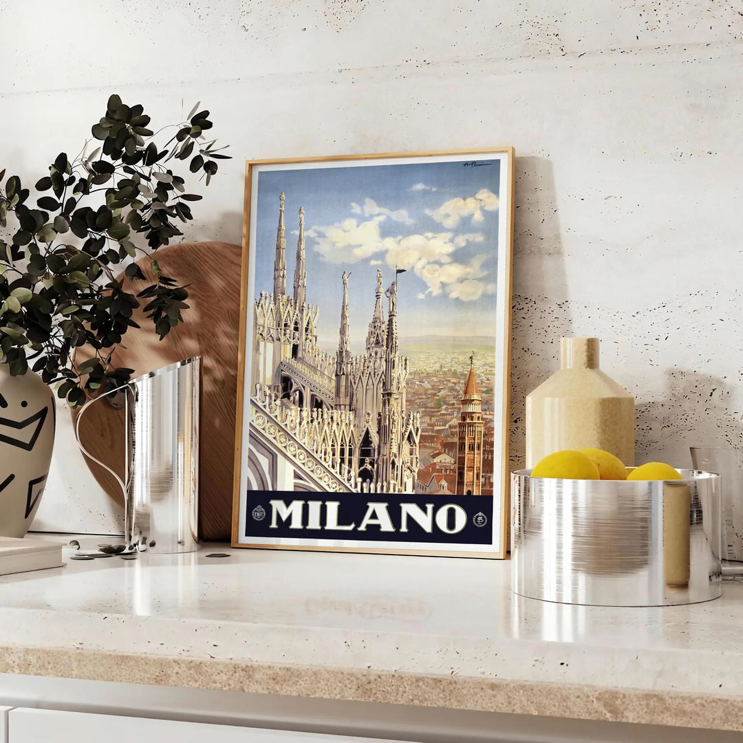 Stylized illustration of Milan's skyline in black and green - styled on a counter with eucalyptus and a bowl of lemons