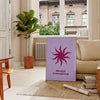A serene yoga scene with calming blue and purple tones - in a Parisian living room with a sofa and a fig plant
