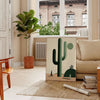 A minimalist cactus illustration in black and gray tones - in a Parisian living room with a sofa and a fig plant
