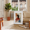 Minimalist portrait featuring bold red and green colors - in a Parisian living room with a sofa and a fig plant