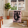 A reflective disco ball surrounded by abstract black and orange patterns - in a Parisian living room with a sofa and a fig plant