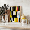 Abstract composition with orange and black shapes in a modern style - styled on a counter with eucalyptus and a bowl of lemons
