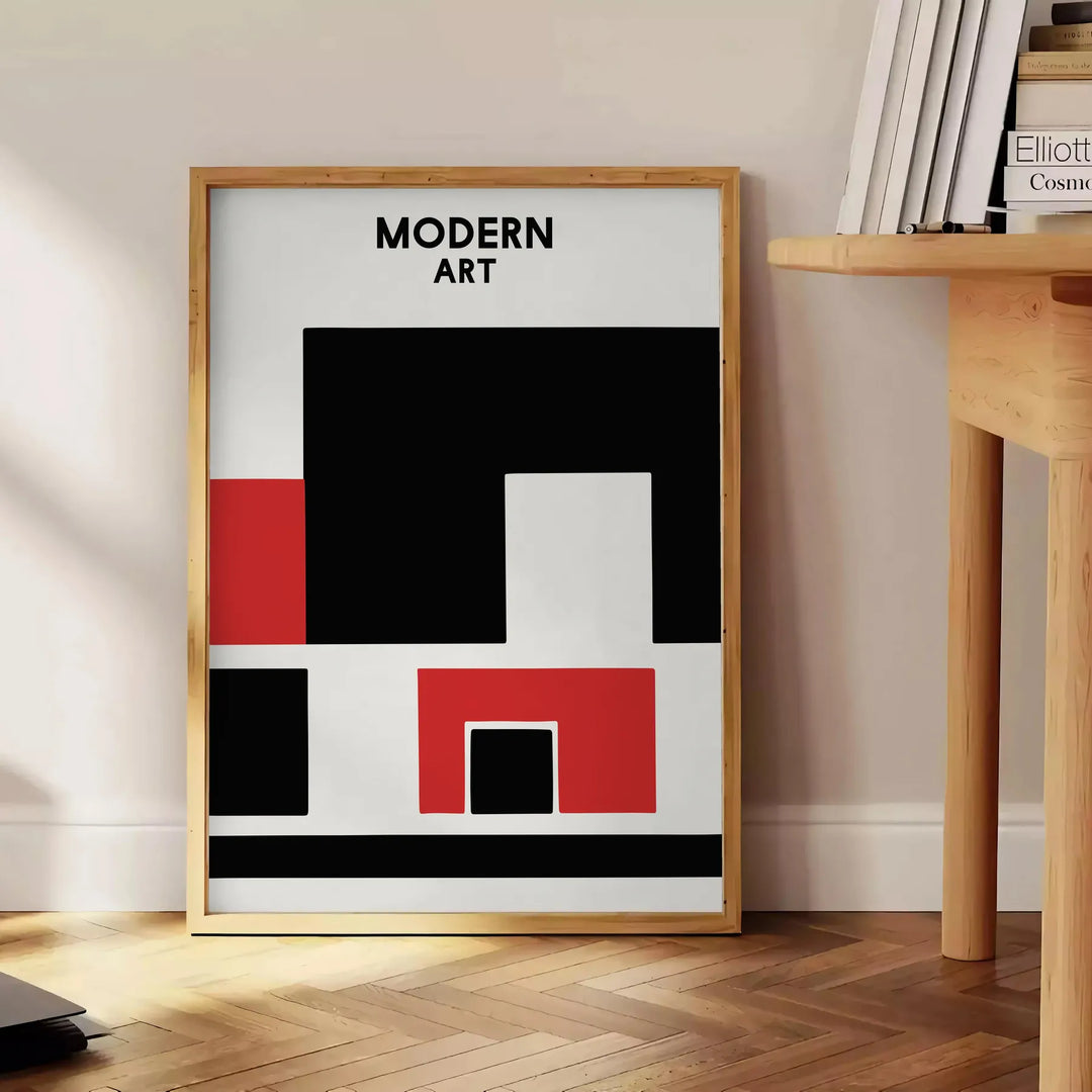 Composição abstrata com formas dinâmicas em preto e vermelho - ao lado de uma mesa de apoio redonda em madeira com livros