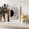 abstract black and white design depicting an imaginative cosmic landscape - styled on a counter with eucalyptus and a bowl of lemons