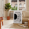 abstract black and white design depicting an imaginative cosmic landscape - in a Parisian living room with a sofa and a fig plant