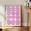 Abstract modern art with brown and white hues in a space theme - beside a round wooden side table with books