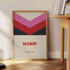 Abstract modern art with black and brown tones, featuring geometric shapes - beside a round wooden side table with books