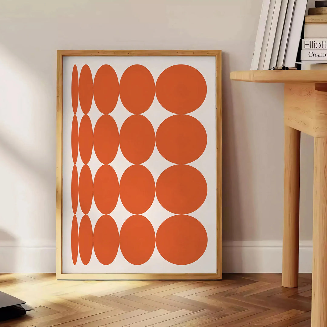 Abstract composition with orange and earthy brown tones in a modern style - beside a round wooden side table with books