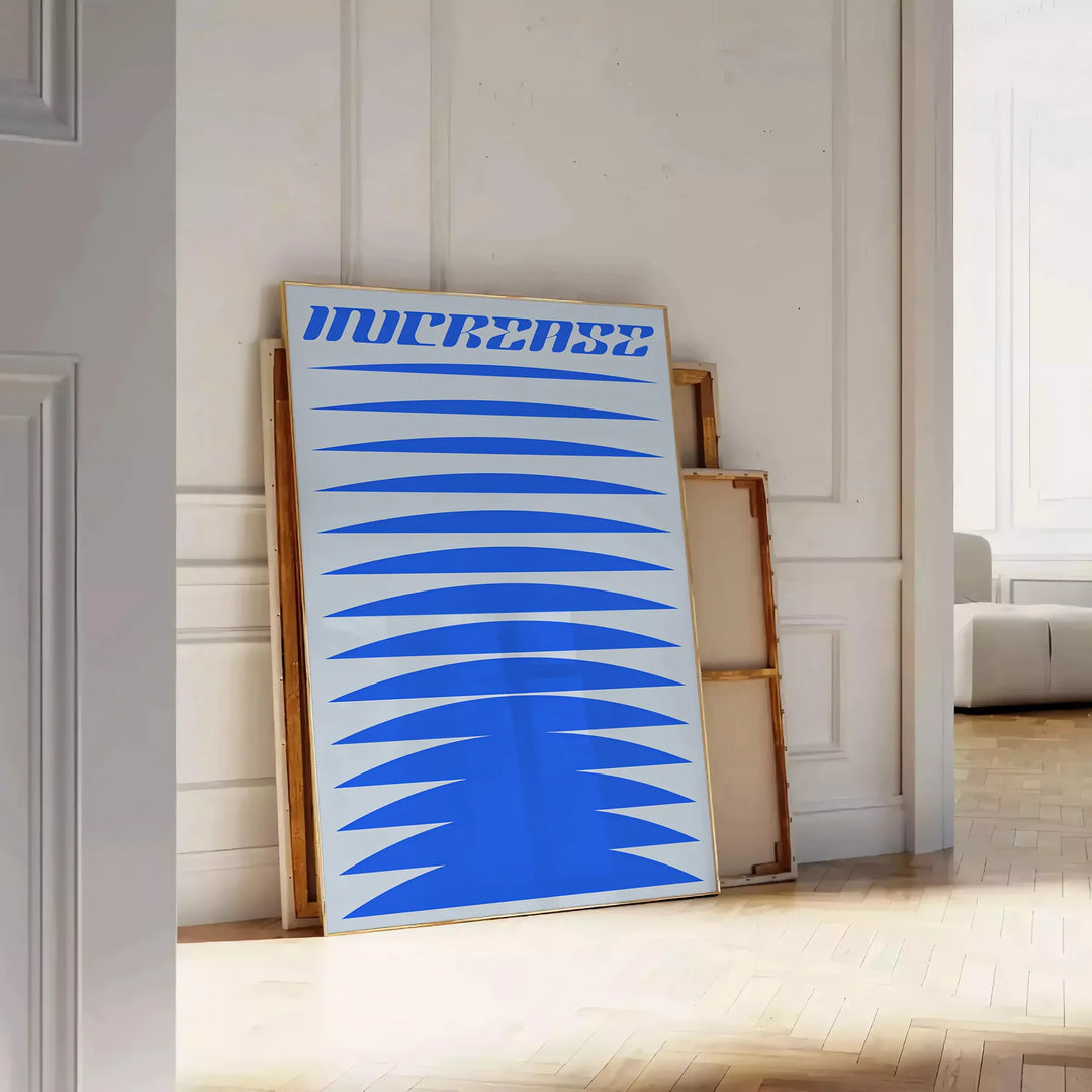 Abstract modern art with dynamic blue and gray shapes - leaning on a herringbone floor against a white panelled wall