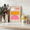 Abstract modern art with gray and orange hues depicting a cosmic theme - styled on a counter with eucalyptus and a bowl of lemons