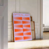 Abstract composition with orange and blue shapes in a modern style - leaning on a herringbone floor against a white panelled wall