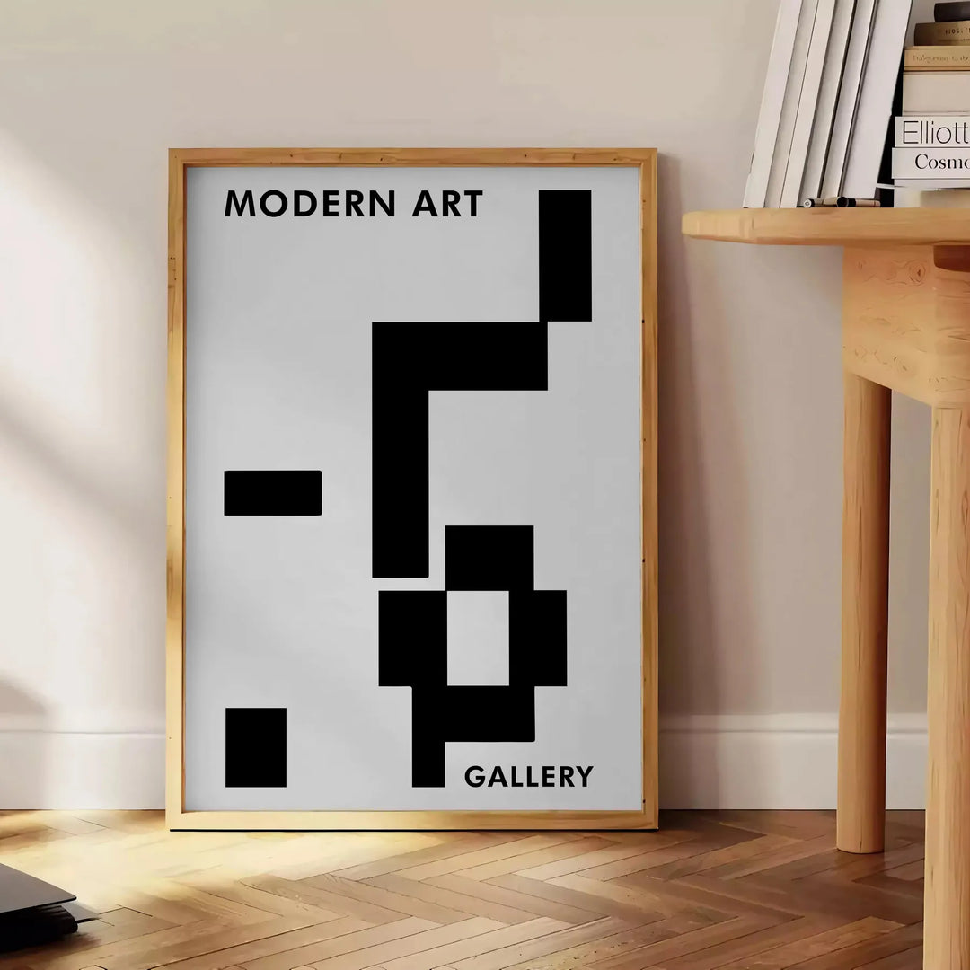 Abstract composition with black and blue shapes and lines - beside a round wooden side table with books