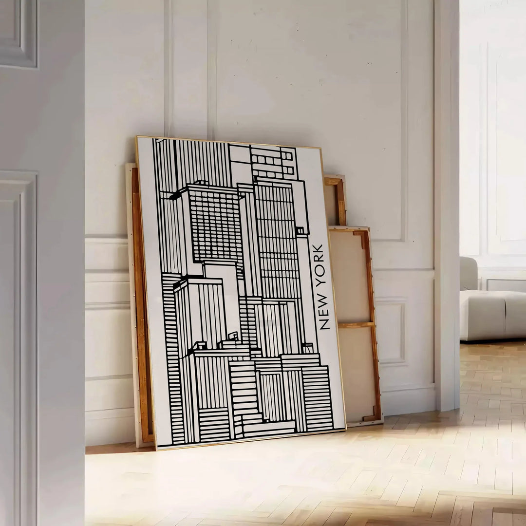 Abstract shapes in bold black and vibrant orange on a modern art poster - leaning on a herringbone floor against a white panelled wall