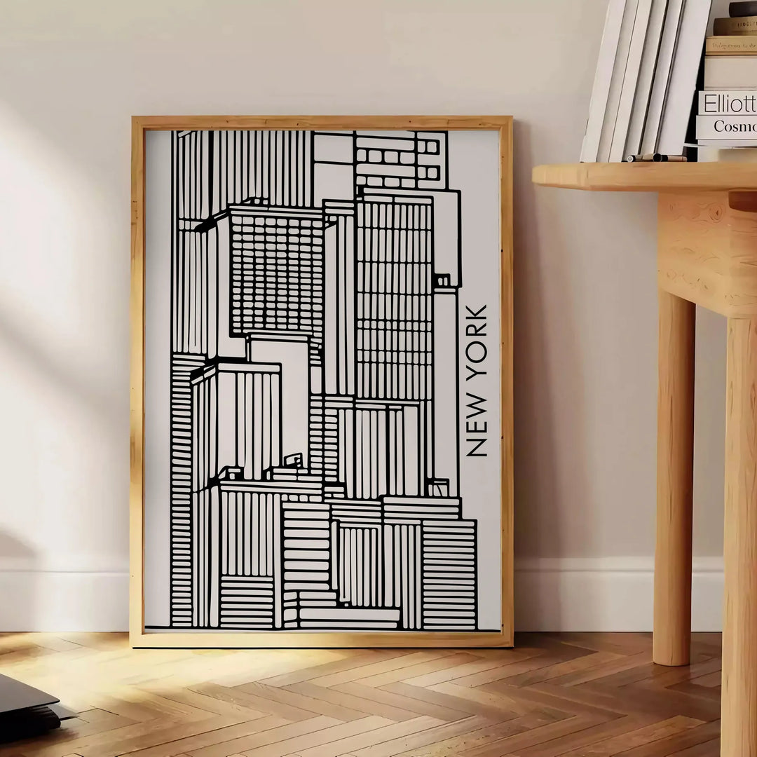 Abstract shapes in bold black and vibrant orange on a modern art poster - beside a round wooden side table with books