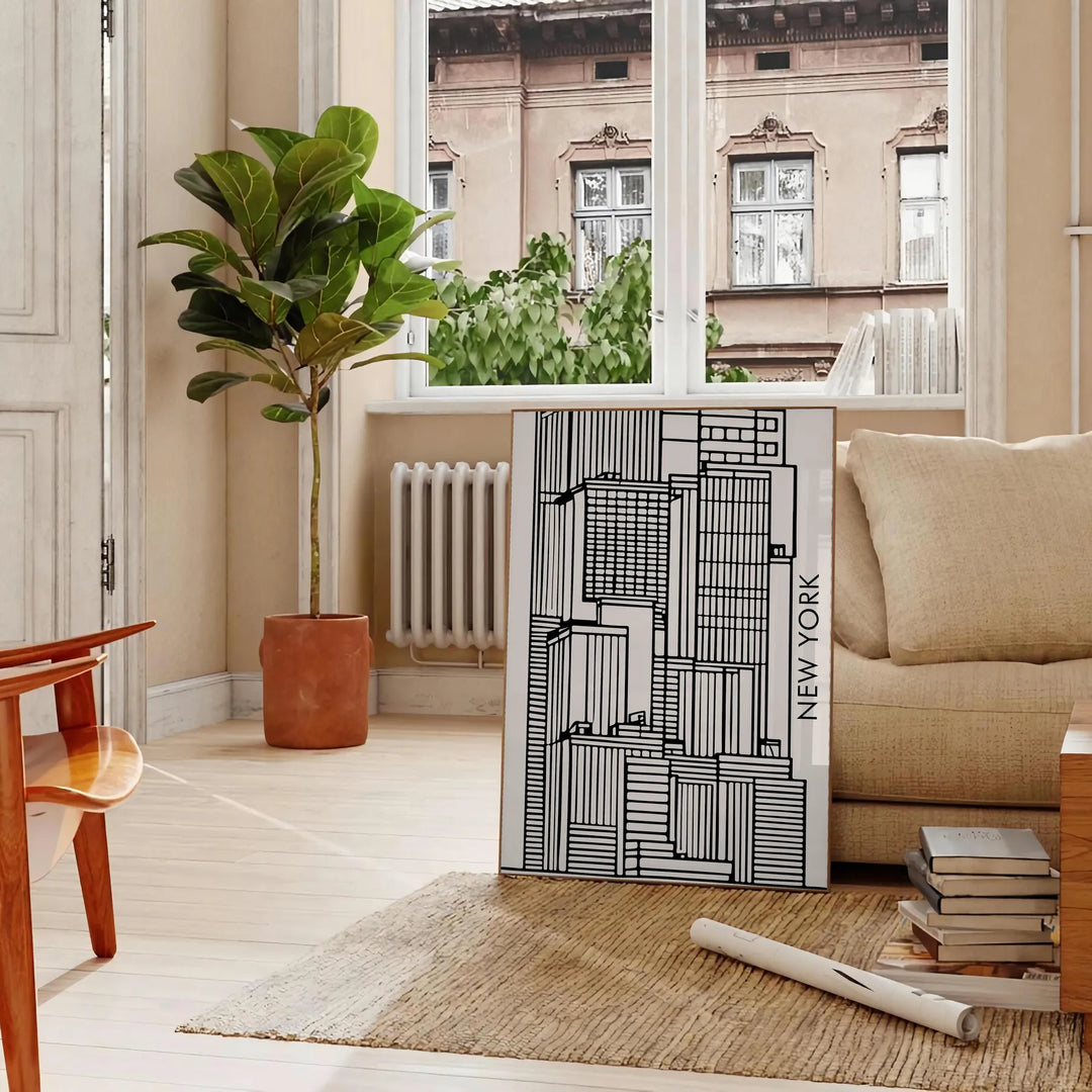 Abstract shapes in bold black and vibrant orange on a modern art poster - in a Parisian living room with a sofa and a fig plant