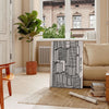 Abstract shapes in bold black and vibrant orange on a modern art poster - in a Parisian living room with a sofa and a fig plant