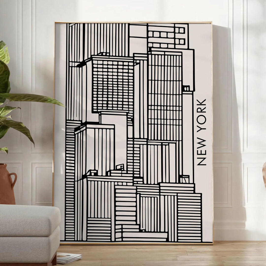 Abstract shapes in bold black and vibrant orange on a modern art poster - in a bright minimalist room with a plant and an armchair