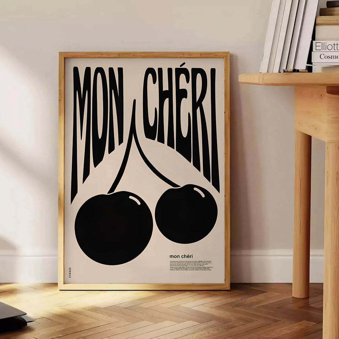 Abstract design featuring cherries in black and orange hues - beside a round wooden side table with books