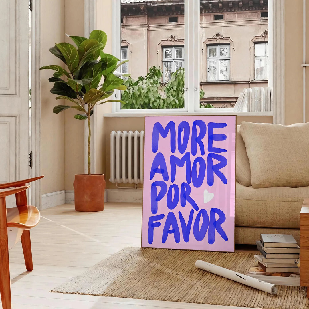 Stylized text 'More Amor Por Favor' in blue and purple tones - in a Parisian living room with a sofa and a fig plant
