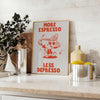 A kitchen print featuring bold orange and blue typography with coffee motifs - styled on a counter with eucalyptus and a bowl of lemons