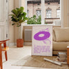 Abstract space scene in green and purple with motivational text - in a Parisian living room with a sofa and a fig plant