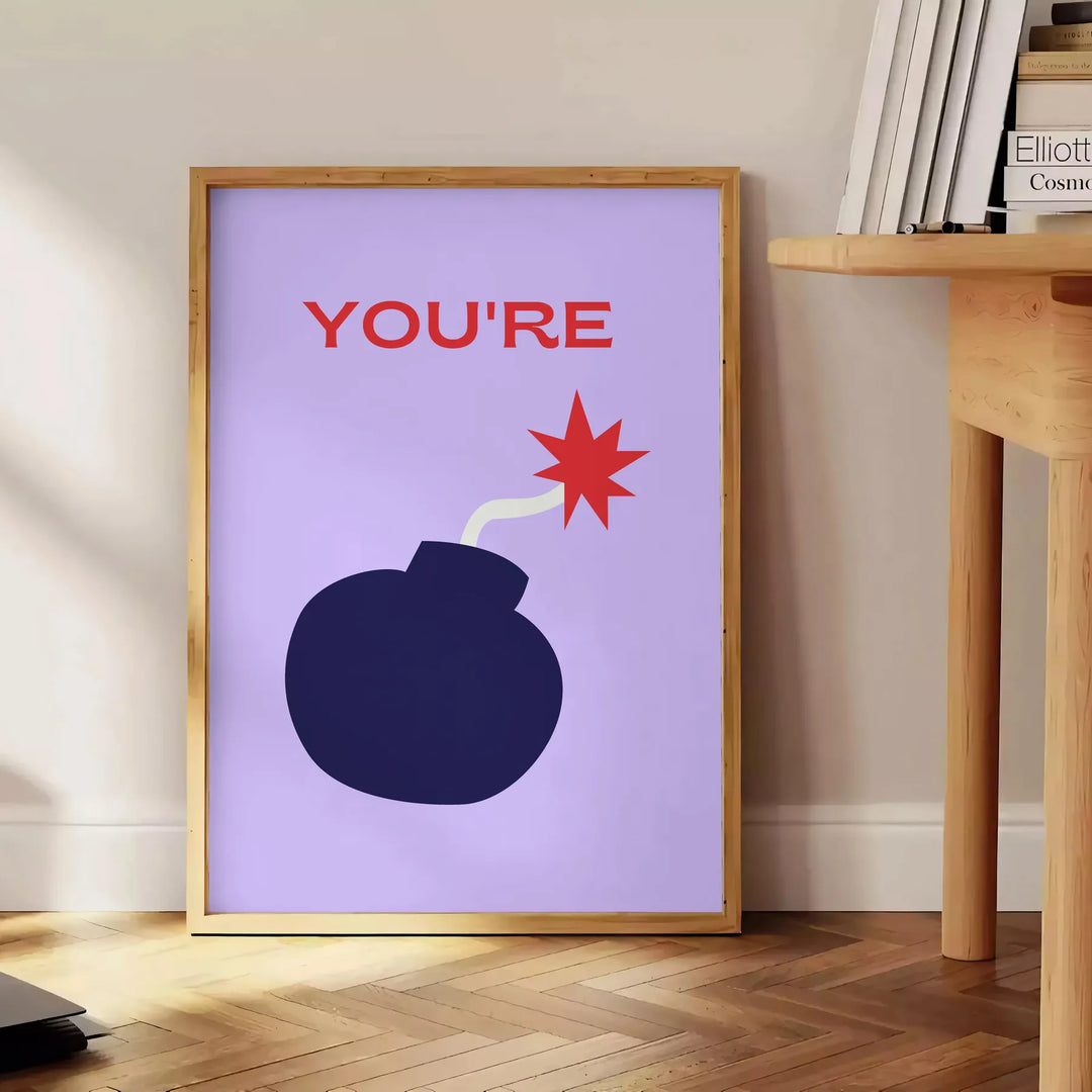 Abstract design featuring orange and blue tones with motivational text - beside a round wooden side table with books