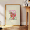 Abstract design featuring green and orange hues with motivational text - beside a round wooden side table with books