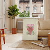 Abstract design featuring green and orange hues with motivational text - in a Parisian living room with a sofa and a fig plant