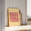 A motivational poster featuring abstract space imagery in rich brown and orange tones - leaning on a herringbone floor against a white panelled wall