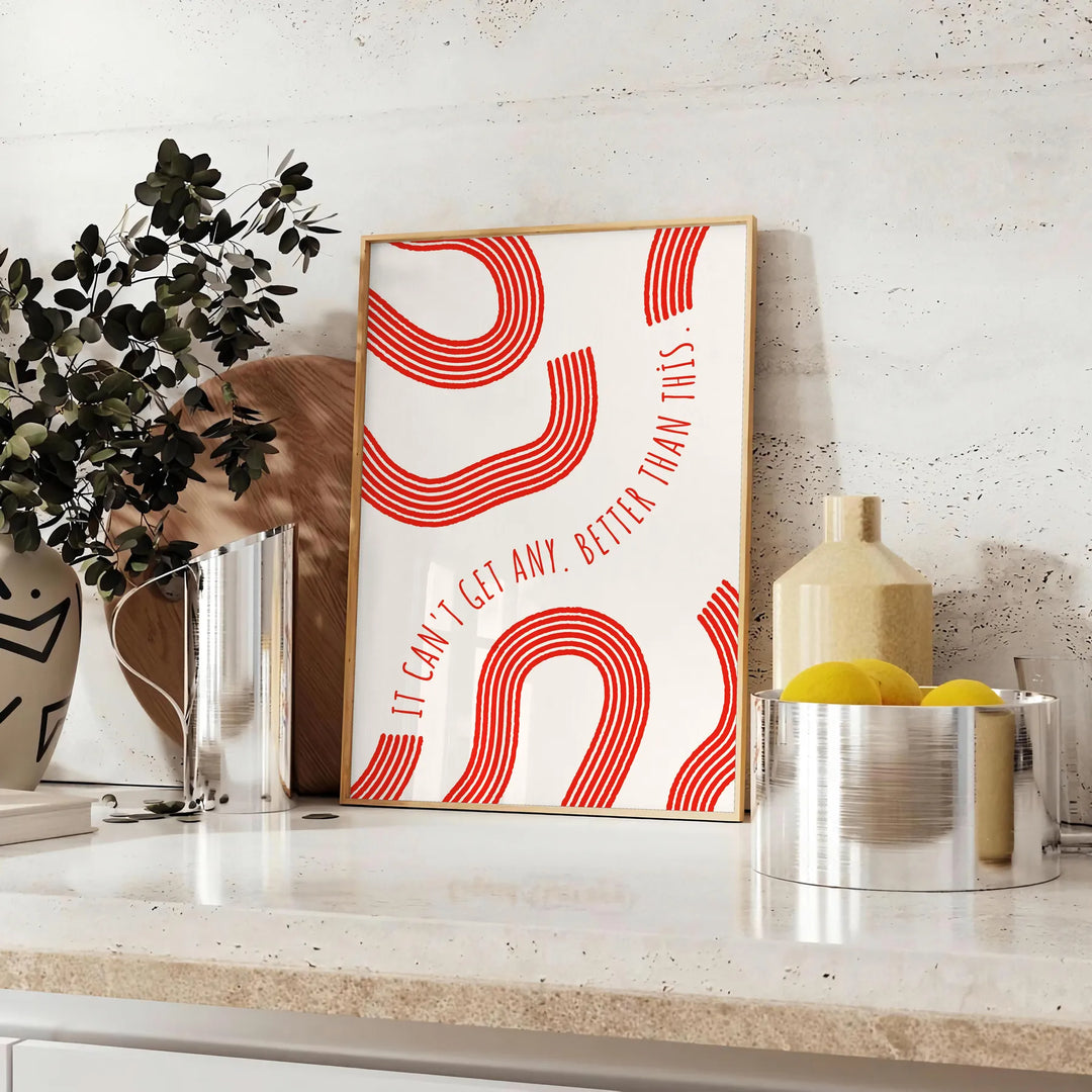 Red and white motivational poster with abstract space elements and inspirational text - styled on a counter with eucalyptus and a bowl of lemons