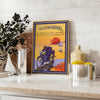 A dynamic illustration of a motorcycle on a road, with blue and yellow hues. - styled on a counter with eucalyptus and a bowl of lemons