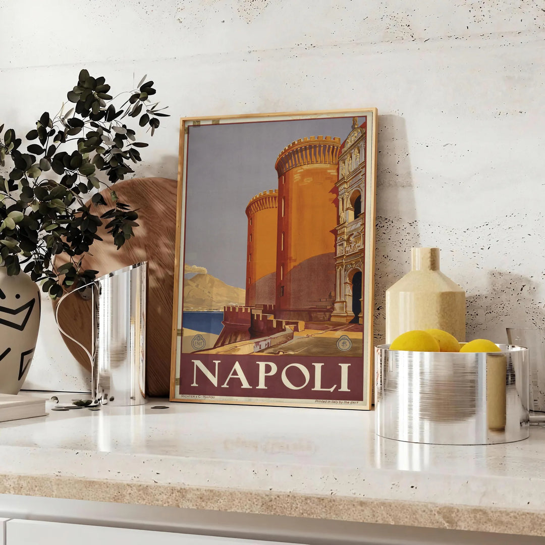 Illustration of Napoli with green and orange colors, featuring iconic landmarks - styled on a counter with eucalyptus and a bowl of lemons