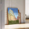A serene landscape featuring lush green trees and earthy brown mountains in a national park. - leaning on a herringbone floor against a white panelled wall