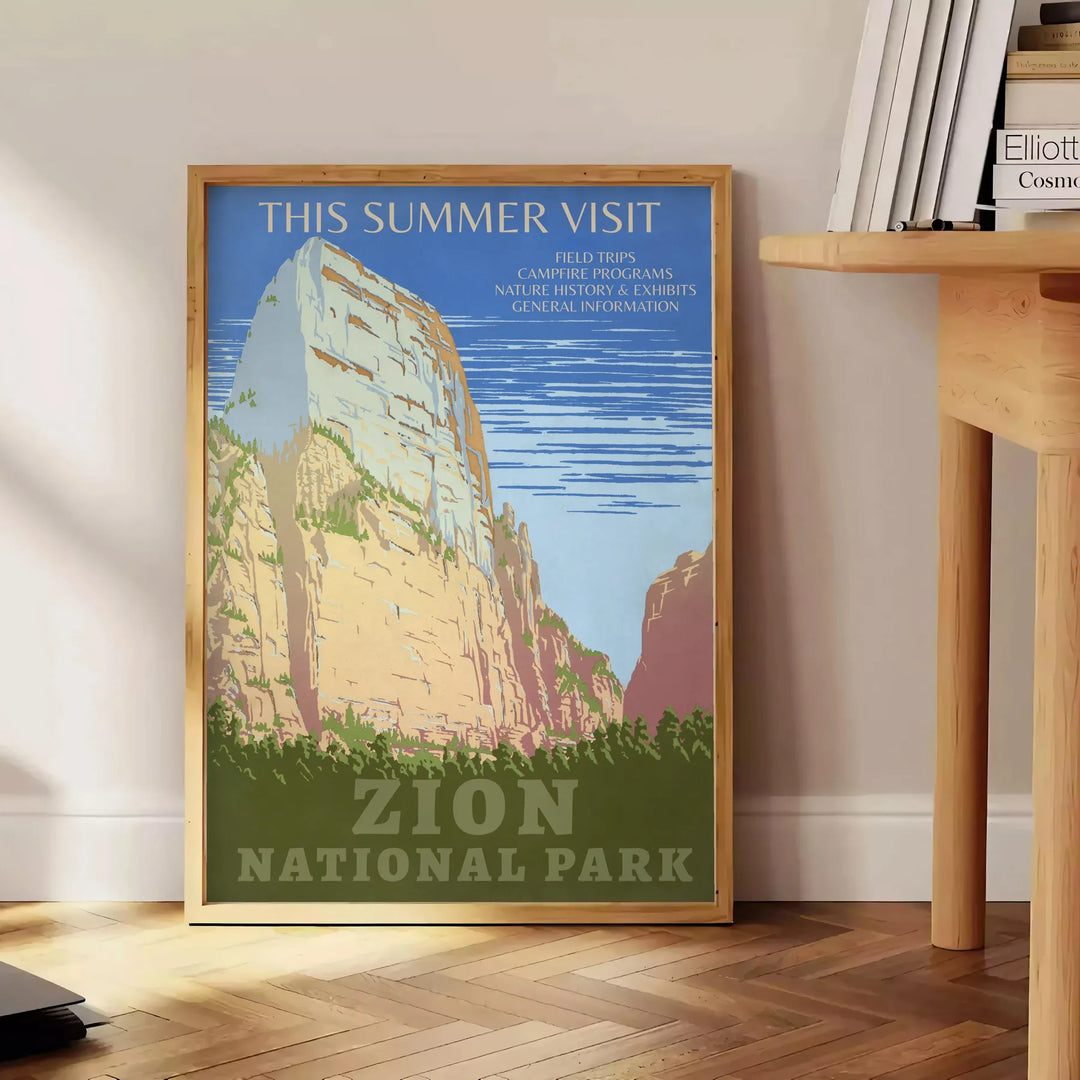 A serene landscape featuring lush green trees and earthy brown mountains in a national park. - beside a round wooden side table with books
