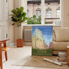 A serene landscape featuring lush green trees and earthy brown mountains in a national park. - in a Parisian living room with a sofa and a fig plant